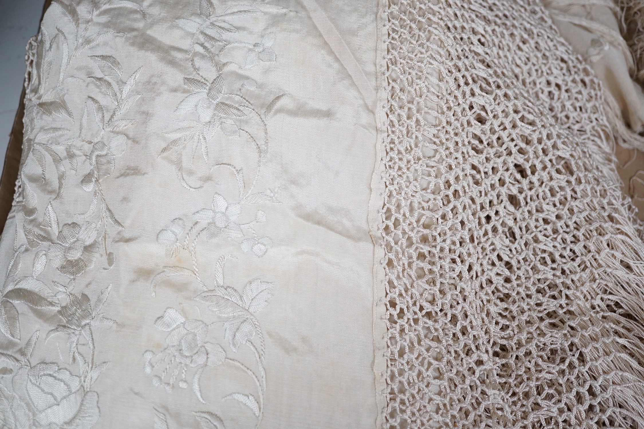 A 19th century cream embroidery on cream silk shawl together with a smaller later shawl